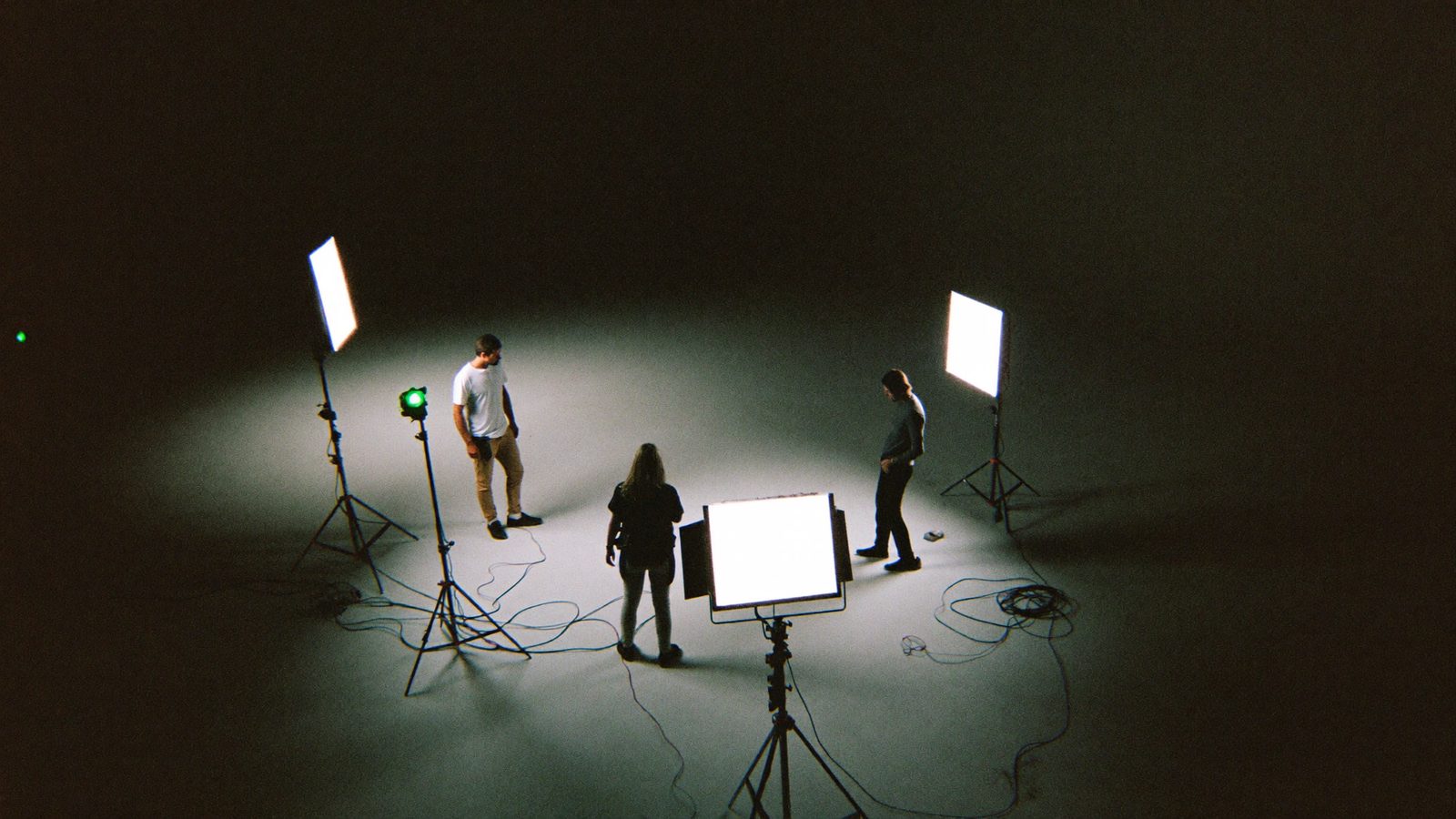 Film set from above: tripods, cables, two LED panels